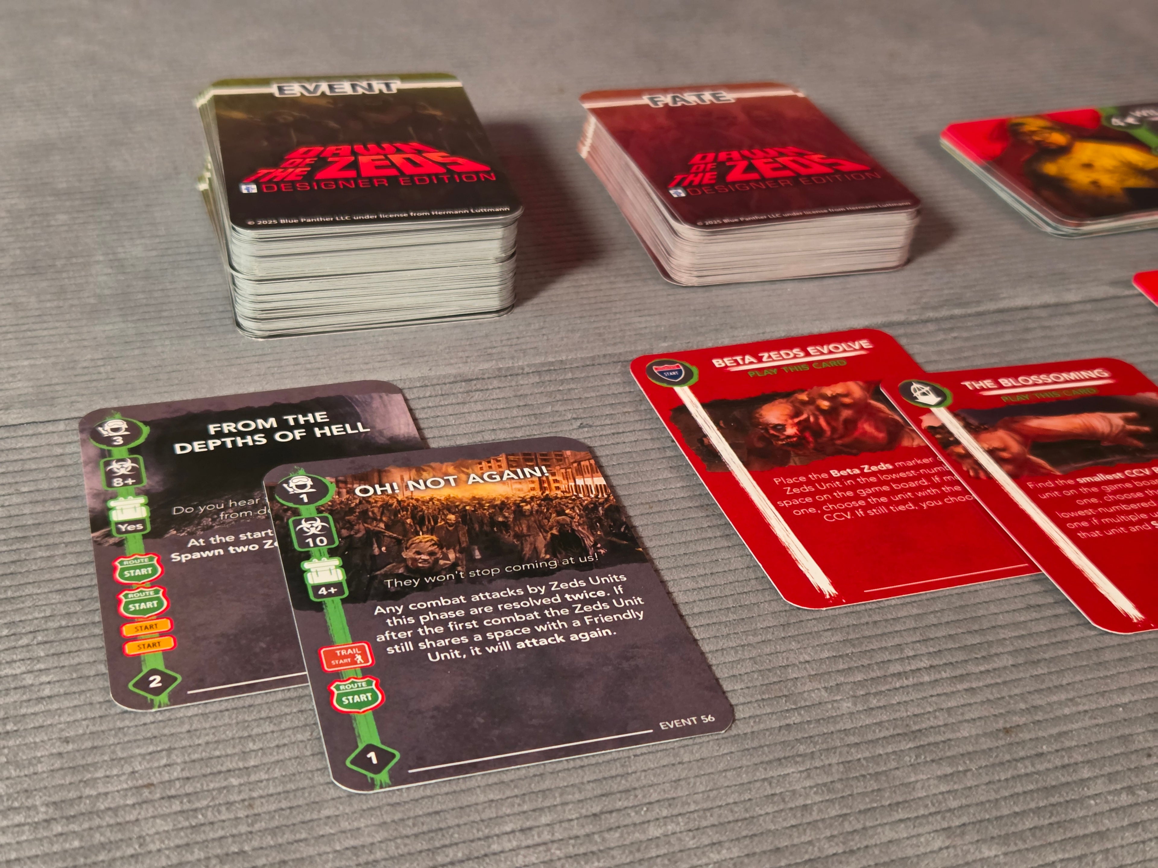Card game with various cards on a gray surface